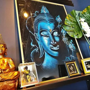a buddha statue and a painting