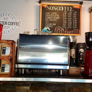 a coffee grinder, coffee cups, and a menu