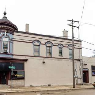 the corner of a building with a car parked in front of it