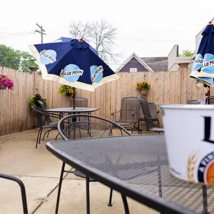 a patio with tables and chairs