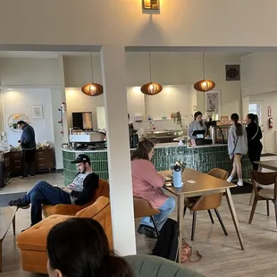people sitting at tables in a cafe
