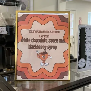 a sign for the white chocolate sauce and blackberry syrup