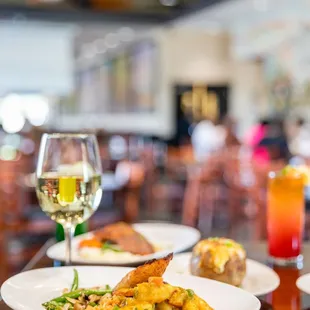 a plate of food and a glass of wine