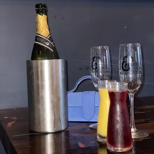 a bottle of champagne and two glasses