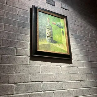 a picture of a painting on a brick wall