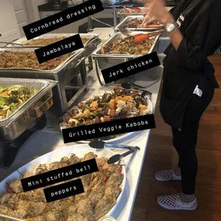 a woman standing in front of a buffet