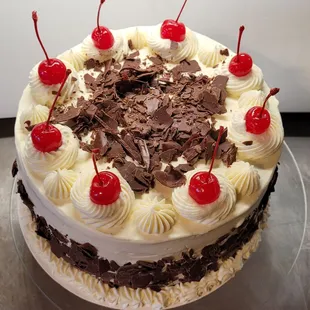 a chocolate cake with cherries on top