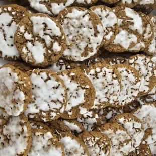 a pile of cookies with icing and sprinkles