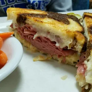 Reuben sandwich served with carrot sticks or chips