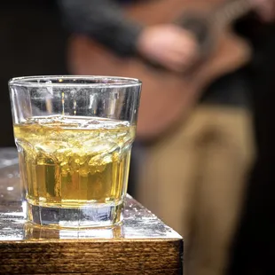 a man playing a guitar in the background