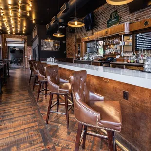 a row of leather bar stools