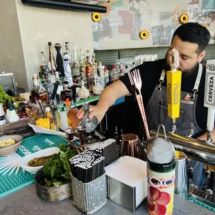 a bartender pouring a drink