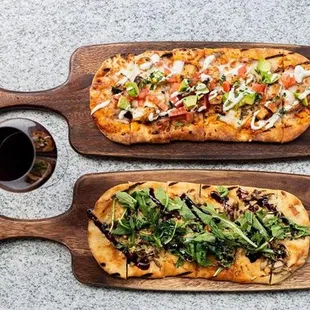 two pizzas on cutting boards