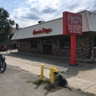 a motorcycle parked in front of a restaurant
