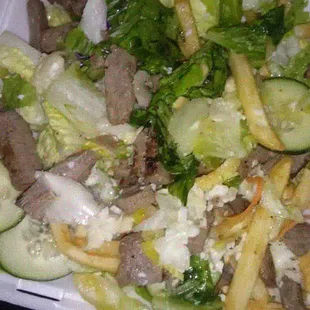 a salad in a styrofoam container
