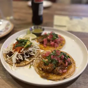 a plate of tacos and a bottle of soda