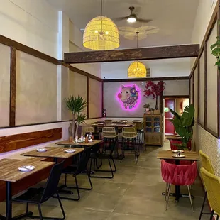 the interior of a restaurant with tables and chairs