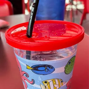 a plastic cup with a straw in it