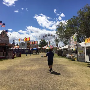 Greg Frisbee juggling as he walks in the direction of the carnival at the 2017 Cochise County Fair.