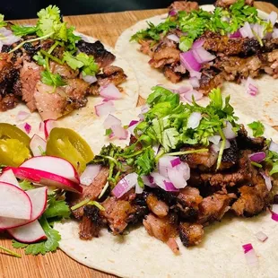 three tacos on a cutting board