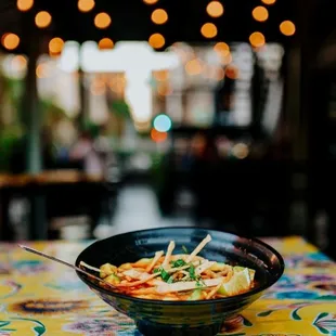 a bowl of noodles on a table