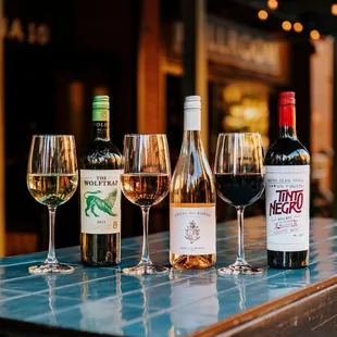a row of wine glasses on a table
