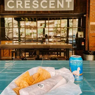 a basket of chips and a can of crescent