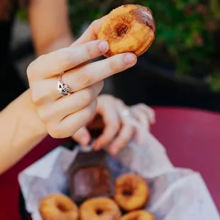 a person holding a donut in their hand