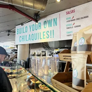 a man standing in front of a display of food