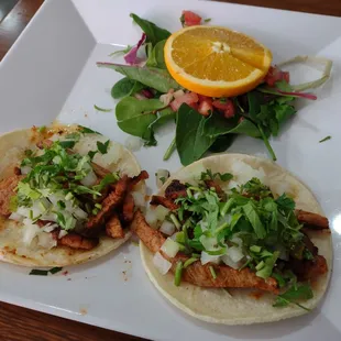 Tacos Al Pastor, fresh salad of mixed greens with pico de gallo, orange action.