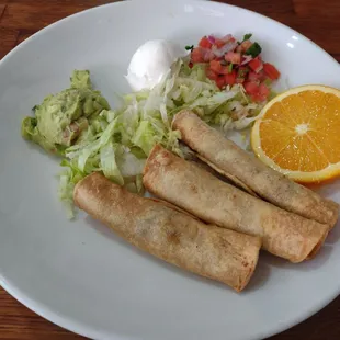 Hand made shredded beef Taquitos. Guac, sour cream, lettuce, tomato, pico de gallo on the side. Keeps the Taquitos warm and crunchy.