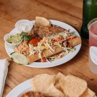 a plate of mexican food and a drink