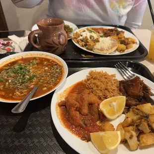 Plate 1: Menudo Plate 2: chicharrones con salsa roja, arroz, pollo con mole y papas con chorizo