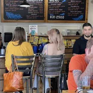 people sitting at tables in a restaurant