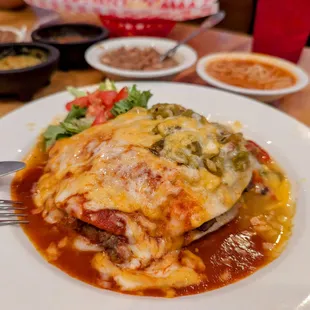 Ribeye enchiladas, Christmas; beans and fideos in background