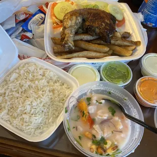 a tray of rice, chicken, and other foods