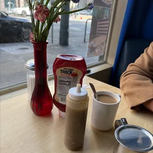 a table with coffee and condiments