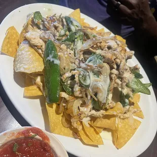 Grilled chicken nachos with grilled onion and jalapeños