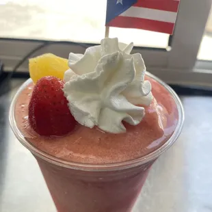 a smoothie with whipped cream and strawberries