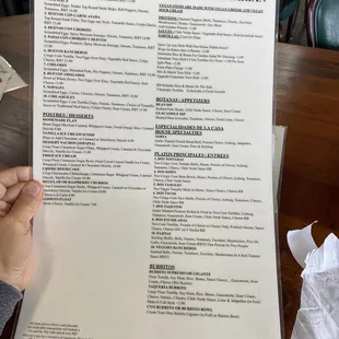 a person holding a menu