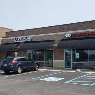a car parked in front of a restaurant