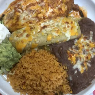 Chili relleno, chicken enchilada with green sauce, rice and beans.