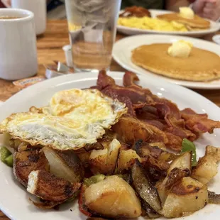 Bacon, over medium eggs, cottage potatoes and sourdough toast