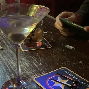 a glass of wine and coasters