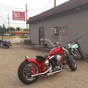 two motorcycles parked in front of a building