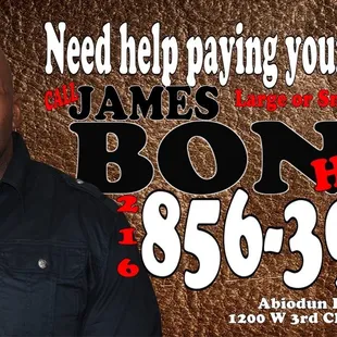 a man standing in front of a brown background