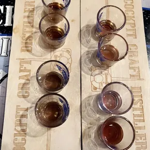 four glasses of beer on a cutting board
