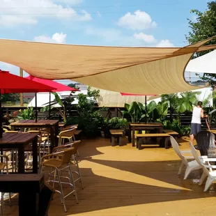 a patio with tables and umbrellas