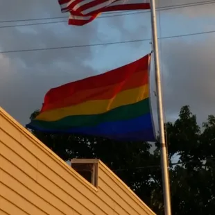 a rainbow flag flying in the wind