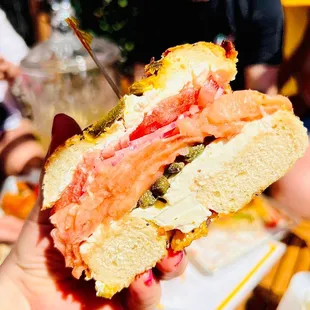 a person holding a sandwich